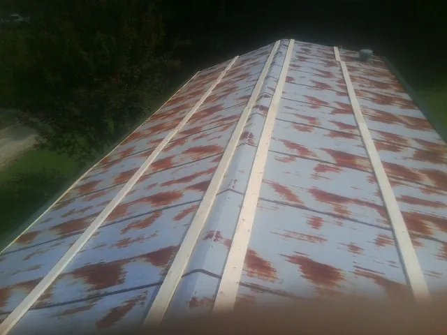 Rusted metal roof panels with new wood purlins before replacement — Storm Damage Roof Repair in Deptford by Roofing Brothers