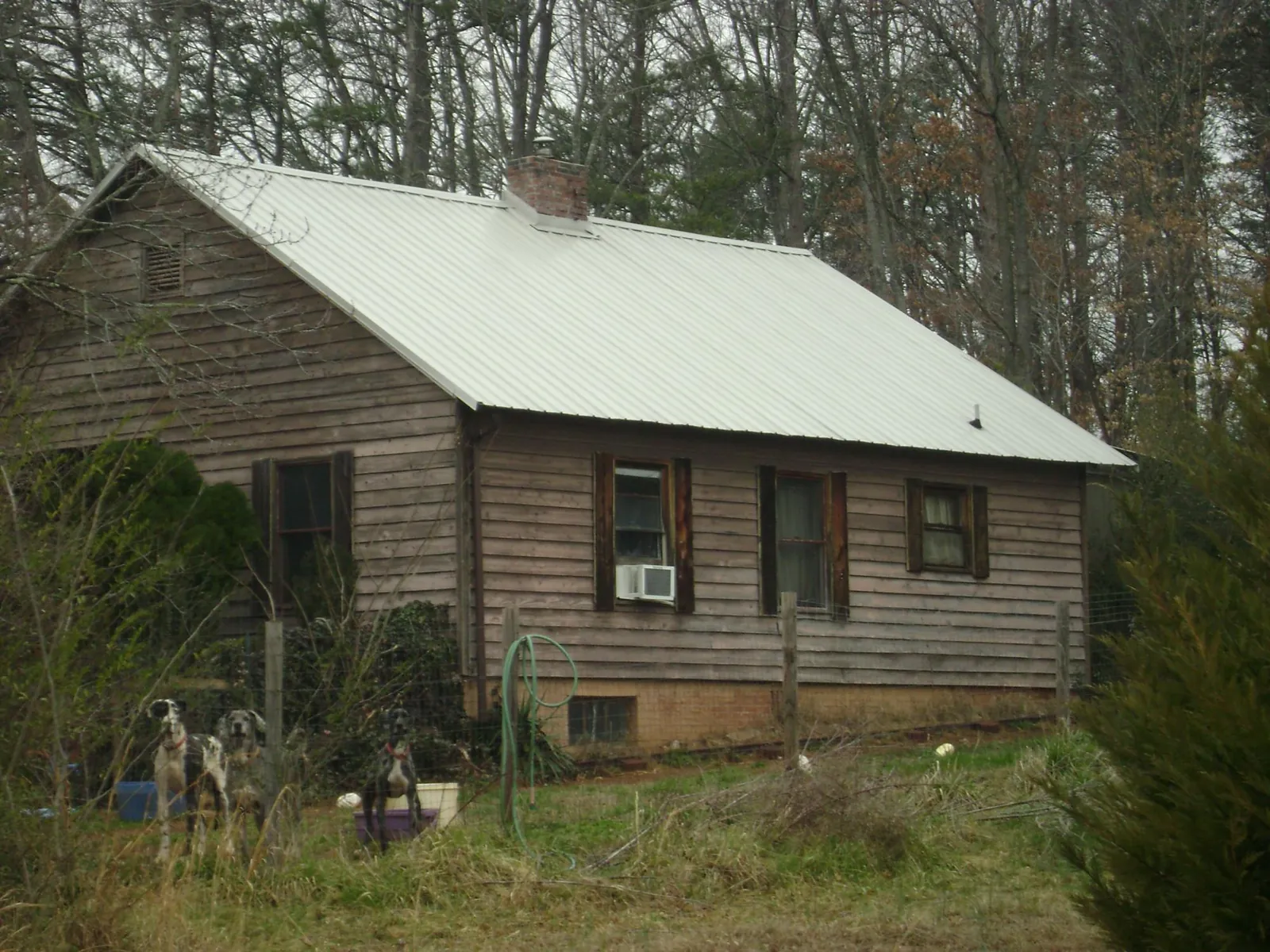 White metal roof on an old wood sided farmhouse, from a Metal Roof Installation job in Deptford